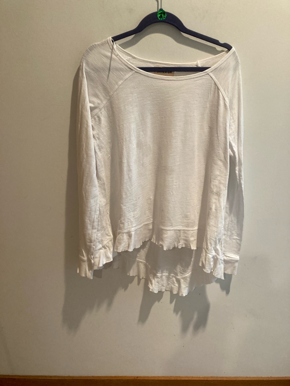 Women’s White Long-Sleeve Lightweight high-low ruffle.
Size large cotton